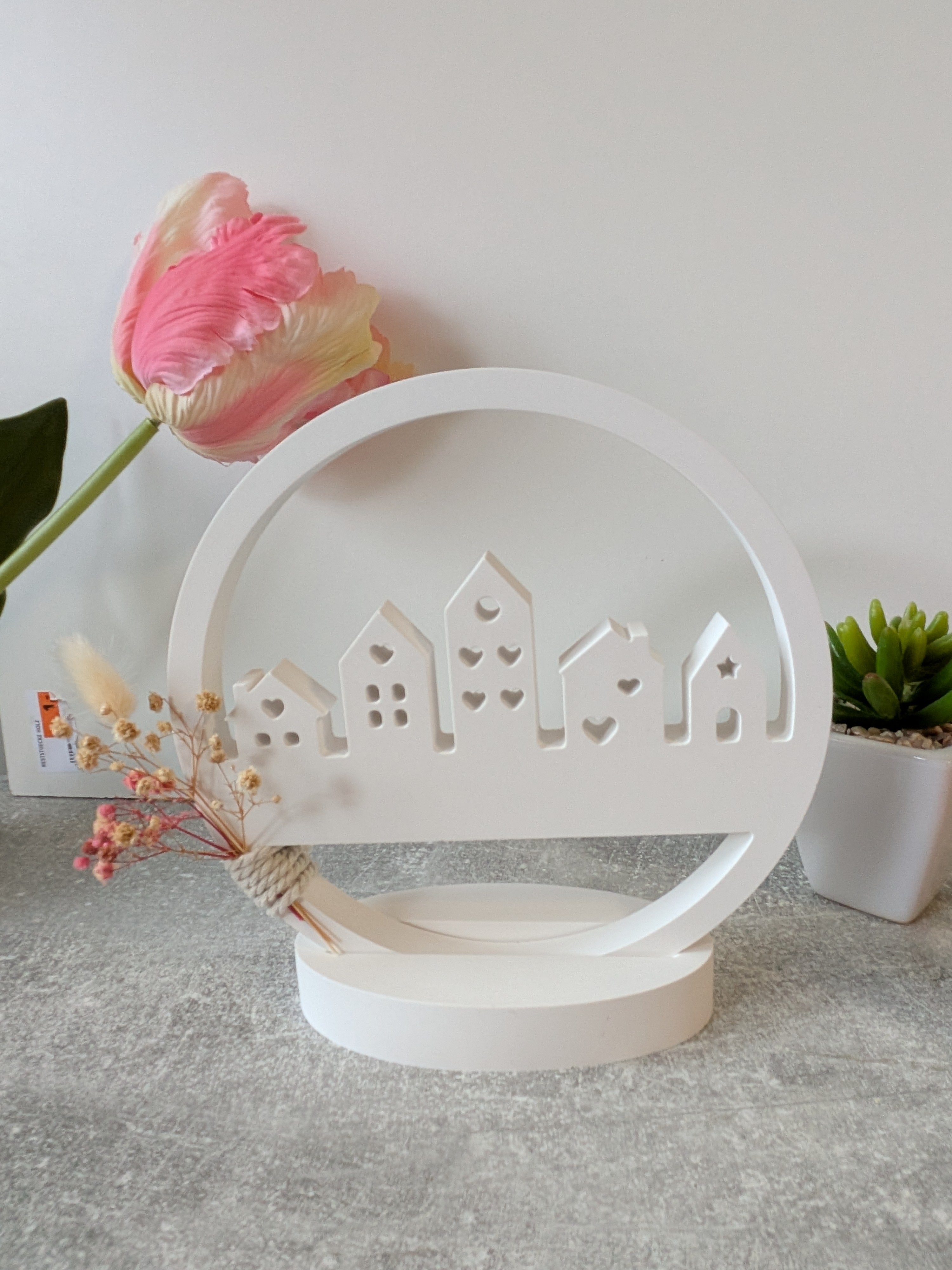 Minimalist house silhouette with integrated dried flowers