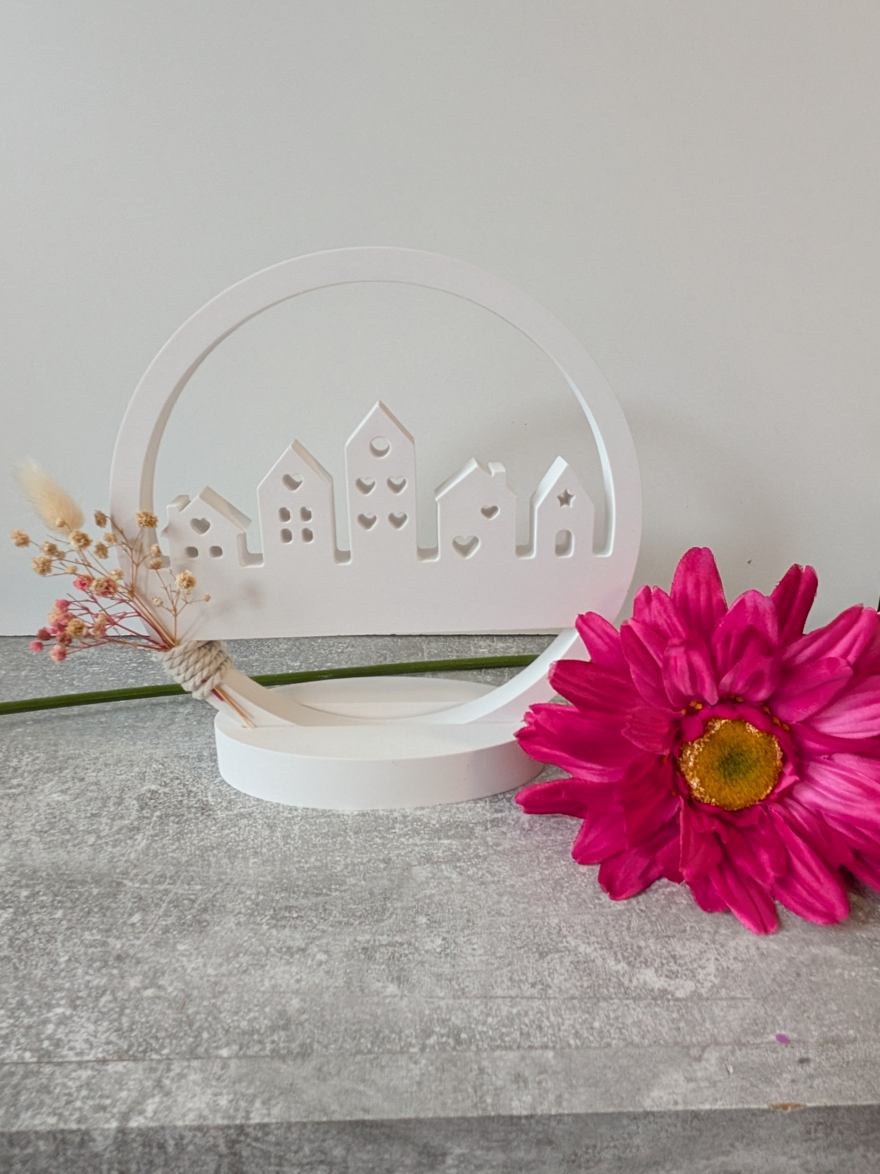 Minimalist house silhouette with integrated dried flowers